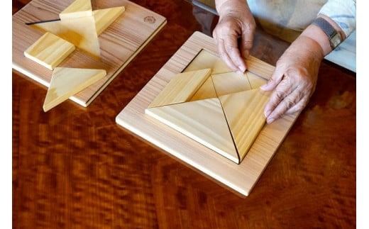 木のおもちゃ パズル ヒノキのタングラム 山のくじら舎 木製 木 おもちゃ 知育玩具 男の子 女の子 ギフト プレゼント 贈り物 贈答 お祝い 出産祝い 誕生日祝い 手作り てづくり 高知県 国産 ヒノキ 図形 シルエット 頭の体操 指先トレーニング 五感 香り 手触り 家族 シニア おじいちゃん おばあちゃん 孫 W247mm×H20mm×D247mm 7個 土台 1個 ガイドブック 1冊 安芸市 高知県